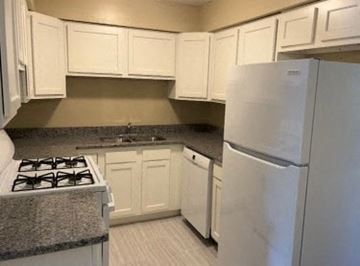 Oak Forest apartment for rent - A kitchen with white cabinets and a white refrigerator.