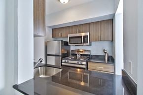 Phoenix apartment for rent - a modern kitchen with stainless steel appliances and wooden cabinets