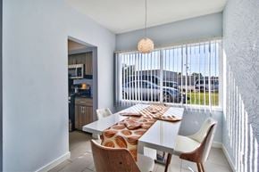 Phoenix apartment for rent - a dining room with a table and chairs and a large window