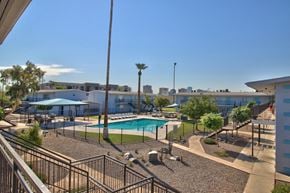 Phoenix apartment for rent - a resort style pool with trees and buildings in the background