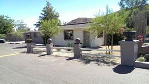 Phoenix apartment for rent - a white house with a fence and a parking lot
