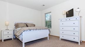 Dekalb apartment for rent - A bedroom with a bed, dresser, and nightstand.