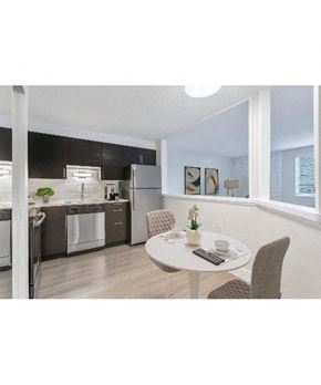 Denver apartment for rent - an open kitchen and dining room with a table and chairs