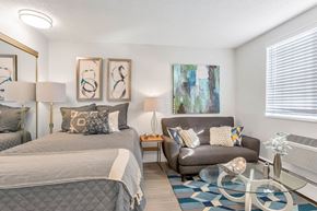 Denver apartment for rent - a bedroom with a bed and a chair and a table