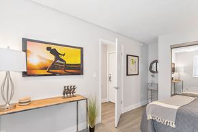 Denver apartment for rent - a bedroom with a bed and a painting on the wall