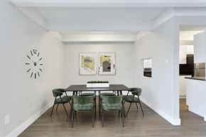 Denver apartment for rent - a dining room with a table and chairs and a clock on the wall