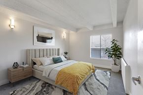 Denver apartment for rent - a bedroom with a bed and a plant