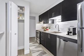 Denver apartment for rent - an apartment kitchen with stainless steel appliances and black cabinets