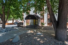 Denver apartment for rent - a building with a black awning and trees in front of it