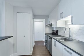 Denver apartment for rent - a kitchen with white cabinets and a sink