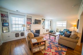 Kansas City triplex for rent - a living room with couches and chairs and a fireplace