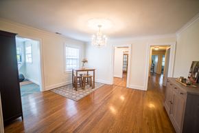 Kansas City triplex for rent - a living room and dining room with a table and a chandelier