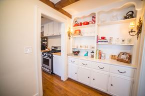 Kansas City triplex for rent - a kitchen with white cabinets and white appliances and shelves