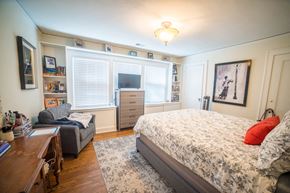 Kansas City triplex for rent - a bedroom with a bed and a couch and a tv