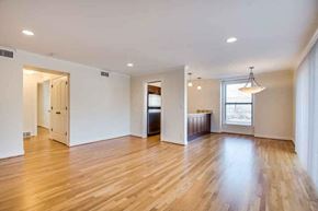 Kansas City apartment for rent - A spacious room with wooden floors and white walls.