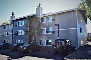 Denver apartment for rent - an apartment building with cars parked in front of it
