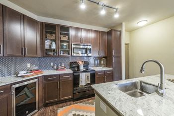 Fully equipped kitchen includes frost-free refrigerator, electric range, & dishwasher