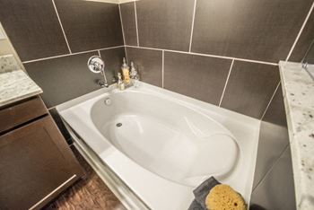 Large soaking tub in master bathroom with a tile surround
