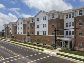 Columbus apartment for rent - A large brick apartment building with a sign that says Parkview Village.