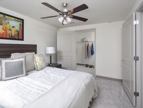Columbus apartment for rent - A bedroom with a large bed and a ceiling fan.