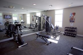 Sheffield Lake apartment for rent - a gym with cardio equipment and mirrors in a building