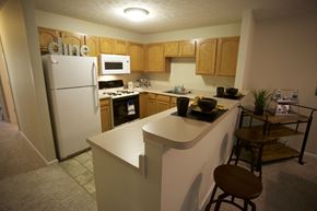 Sheffield Lake apartment for rent - an empty kitchen with a counter and a refrigerator