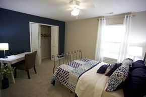 Sheffield Lake apartment for rent - a bedroom with a bed and a desk and two windows