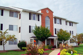 Brook Park apartment for rent - a white house with a red brick chimney and a sidewalk
