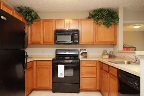 Cuyahoga Falls apartment for rent - a kitchen with black appliances and wooden cabinets