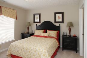 Cuyahoga Falls apartment for rent - a bedroom with a bed and two night stands and a window