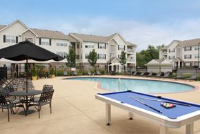 Cuyahoga Falls apartment for rent - our community pool and tables with our apartments in the background