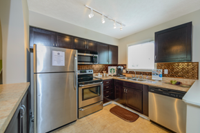 Stow apartment for rent - a kitchen with stainless steel appliances and black cabinets
