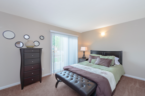 Stow apartment for rent - a bedroom with a bed and a dresser and a window