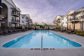 Gahanna apartment for rent - A swimming pool in front of apartment buildings with a sign that says "No Diving 3 FT. 6 M.".