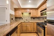Kansas City townhouse for rent - a kitchen with wooden cabinets and a counter top