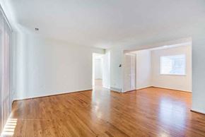 Kansas City apartment for rent - an empty living room with wood floors and white walls