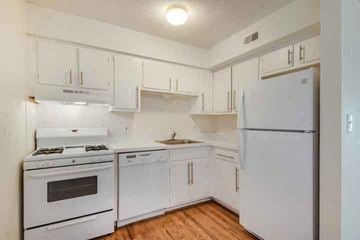 Kansas City apartment for rent - a white kitchen with white appliances and white cabinets