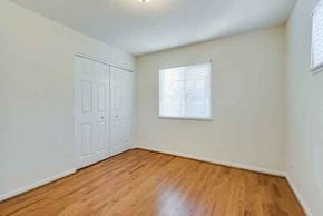 Kansas City apartment for rent - an empty bedroom with a wooden floor and a white door