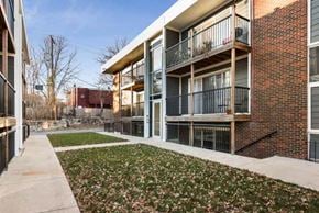 Kansas City apartment for rent - an apartment building with a sidewalk and grass
