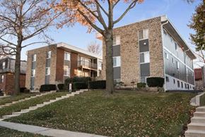 Kansas City apartment for rent - an apartment building with stairs and a yard in front of it