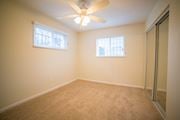 Kansas City apartment for rent - a bedroom with a ceiling fan and a mirrored closet