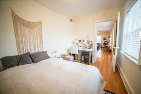 Kansas City apartment for rent - a bedroom with a bed and a living room with a desk