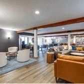 Minnetonka apartment for rent - A living room with a yellow couch and a grey rug.
