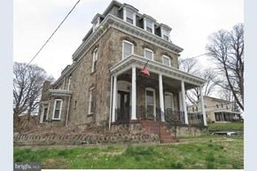 Philadelphia apartment for rent - an old house with a flag on the front of it