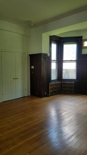 Philadelphia apartment for rent - an empty living room with wood floors and a window