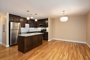 Kansas City apartment for rent - an empty kitchen with a stainless steel refrigerator and