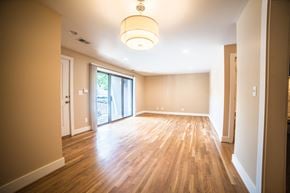 Kansas City apartment for rent - an empty living room with wood floors and a sliding glass door
