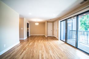Kansas City apartment for rent - an empty living room with sliding glass doors to a balcony