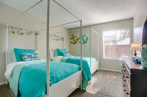 Oceanside apartment for rent - A bedroom with two beds and a dresser.