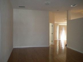 Jacksonville house for rent - A room with wooden floors and white walls.